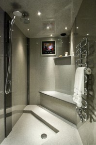 Grey granite wetroom with chrome shower and towel rail.