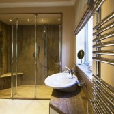 Full bathroom and walk-in shower design created using Versital panels, tops and bespoke shower tray in 'Sandstone'.