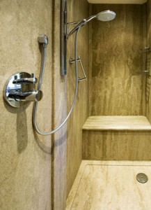 Walk-in shower area with seat - wet room style shower. Using Versital bespoke shower tray, panels and seat in 'Sandstone'