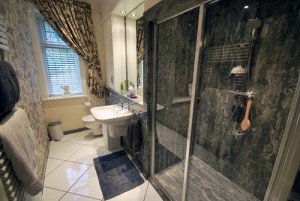 Grey granite style shower bathrooms - luxury solid surface and panels.