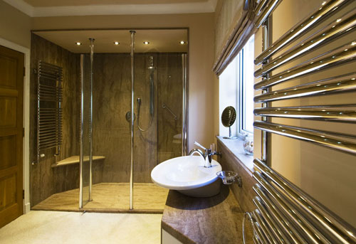 Luxury wetroom style bathroom with walk in shower and top mounted sink.