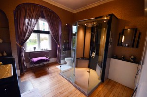 Beautiful master bathroom with a striking feature shower area using a made to measure shower tray in grey sparkle