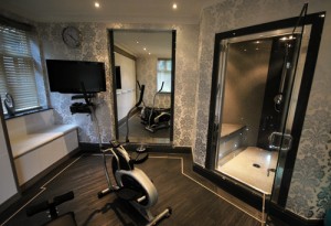 Double seated steamroom in grey granite with black accents.