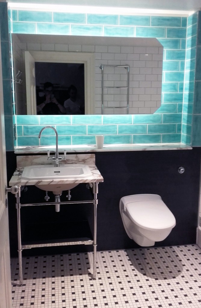 Modern bathroom with turquoise blue tiles and LED lighting