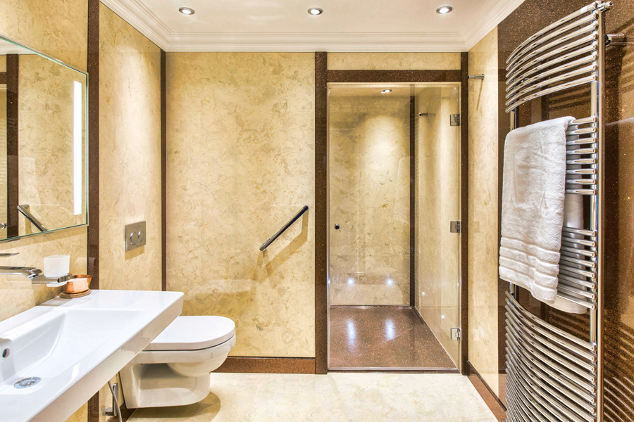 Large walk in bathroom design with marble shower panels and bespoke shower tray