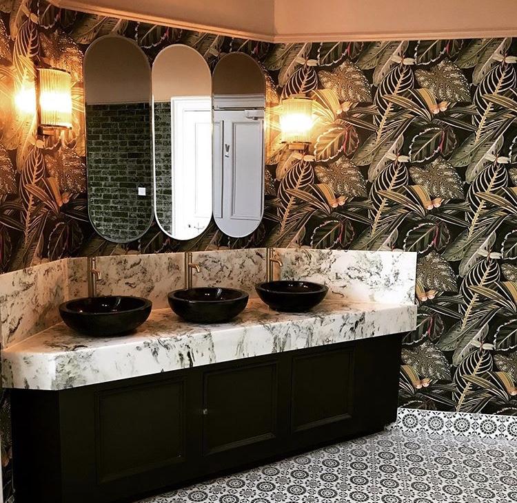 Classic marble bespoke bathroom with a green marble bespoke vanity top
