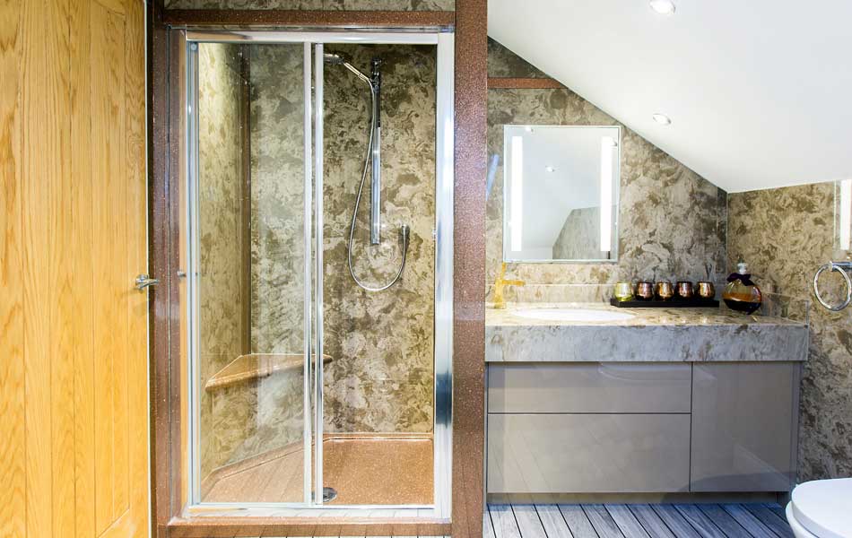 Custom made bathroom design featuring a coffee creme vanity top and wall panels and a keuco mirror cabinet