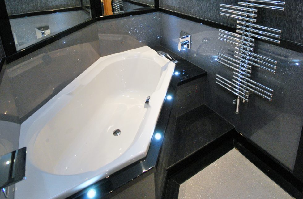 Dark sparkle finish bespoke bathroom, with custom unique shaped bath.