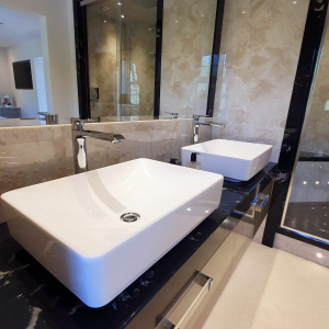 Modern marble bathroom with top mounted rectangular ceramic basins