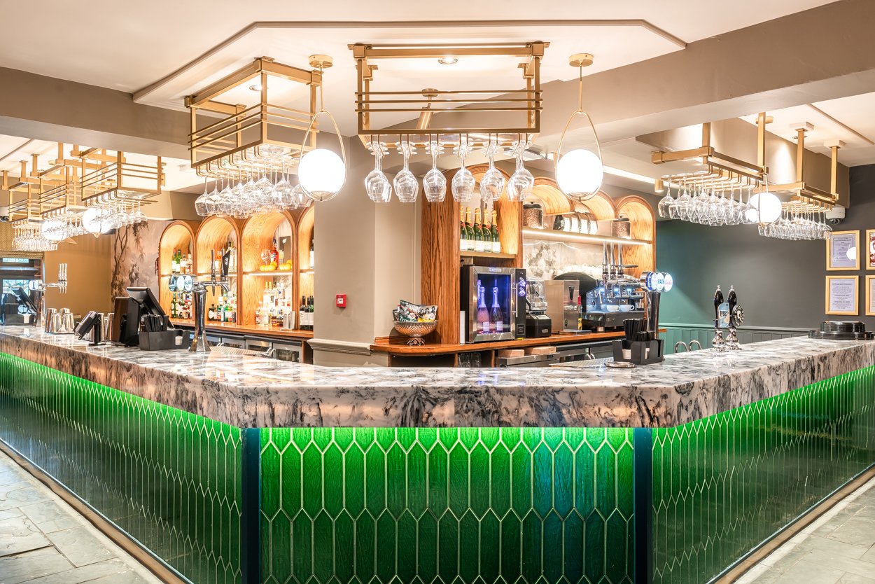 Modern bar with green tile front and cultured marble top