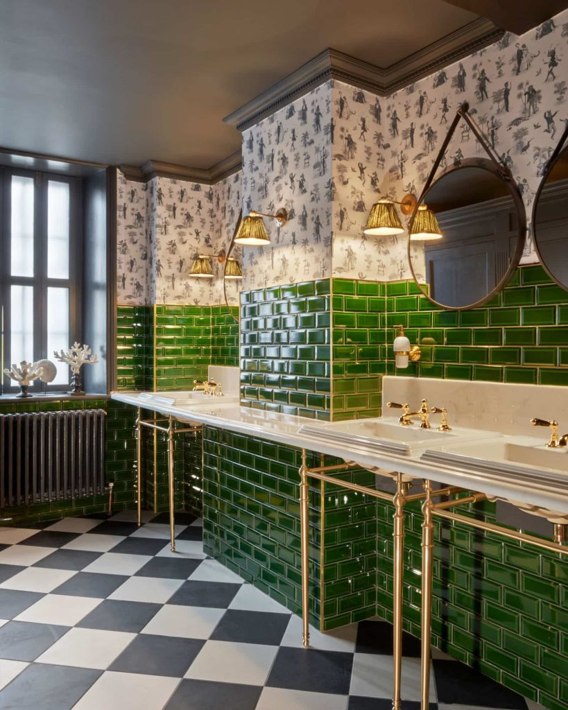 Bespoke classic marble vanity top and green tiling on the walls. With patterned wallpaper.