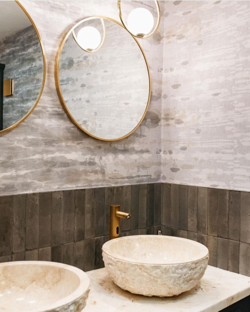 Washroom design using Versital cultured marble vanity top in Caramel and rustic top mounted stone basins