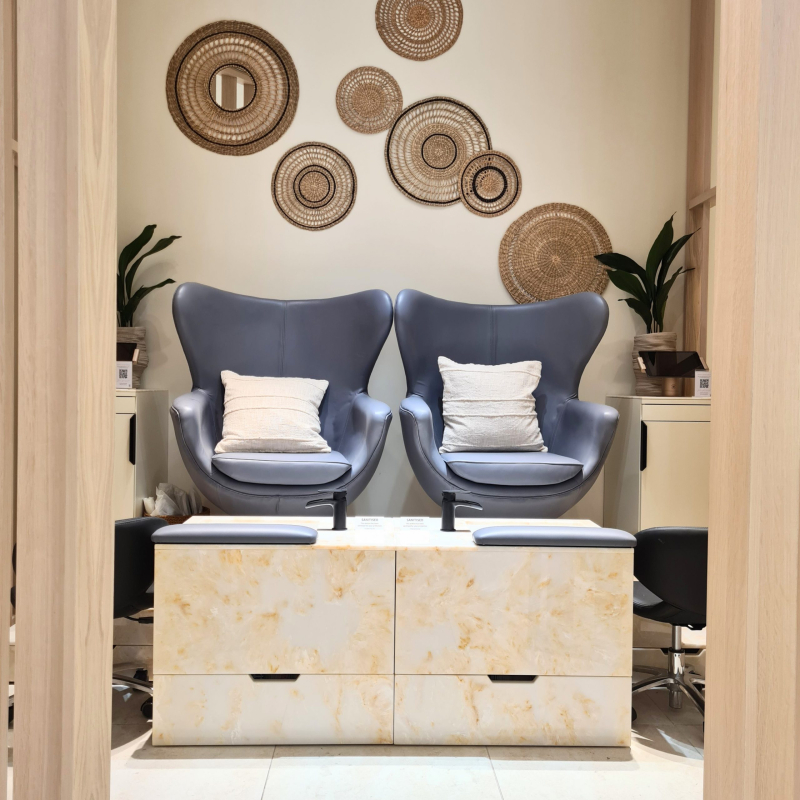 Two seater pedicure seating area in light cream marble