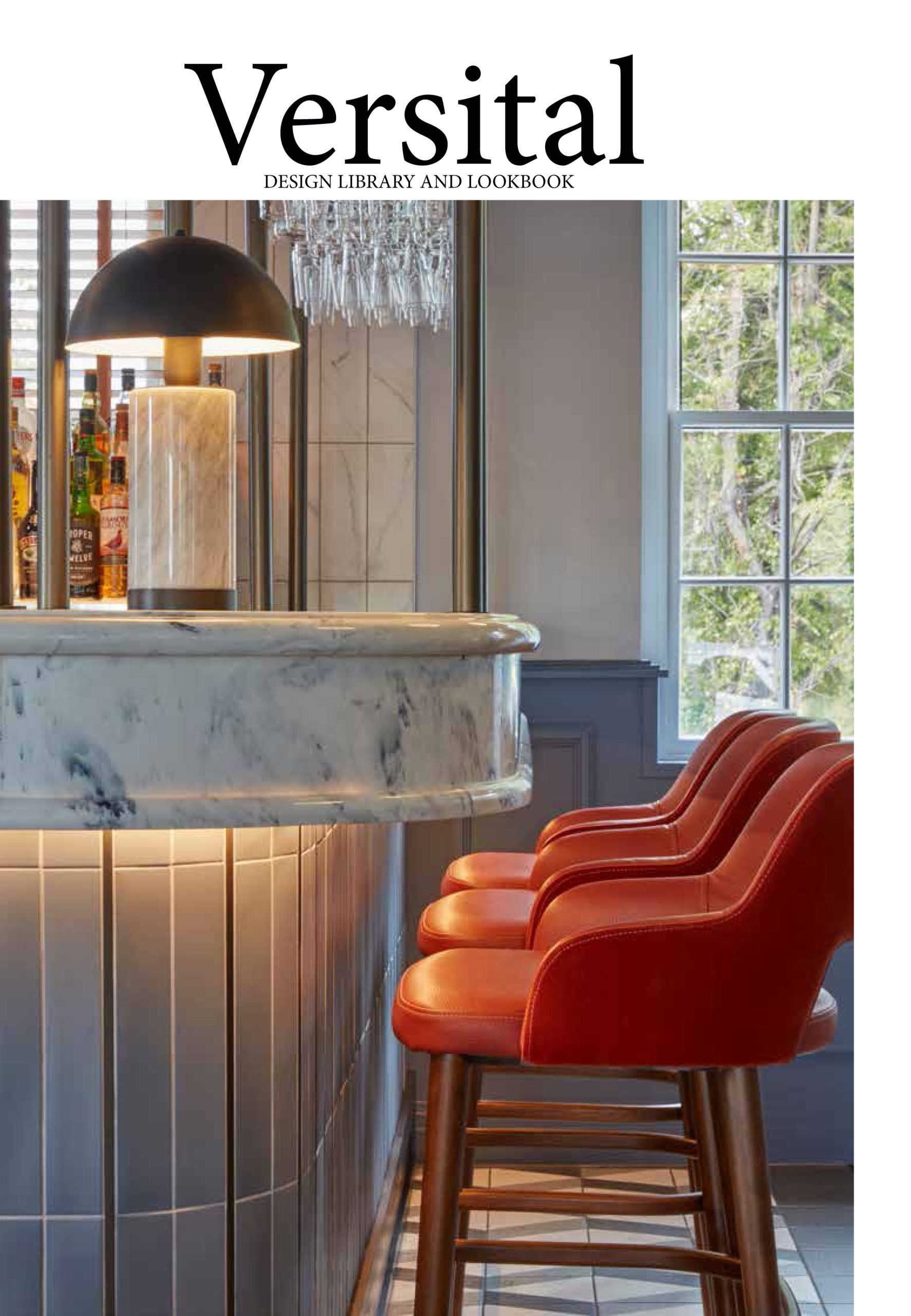 a white marble with black veins bar top with bright red high chairs and a table lap on top of the bar