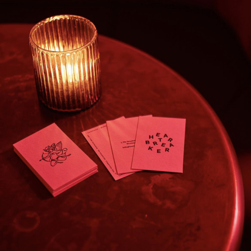 Deep red marble style table tops for the Heartbreaker bar Deep red bar with LED lighting and a pink marble table top